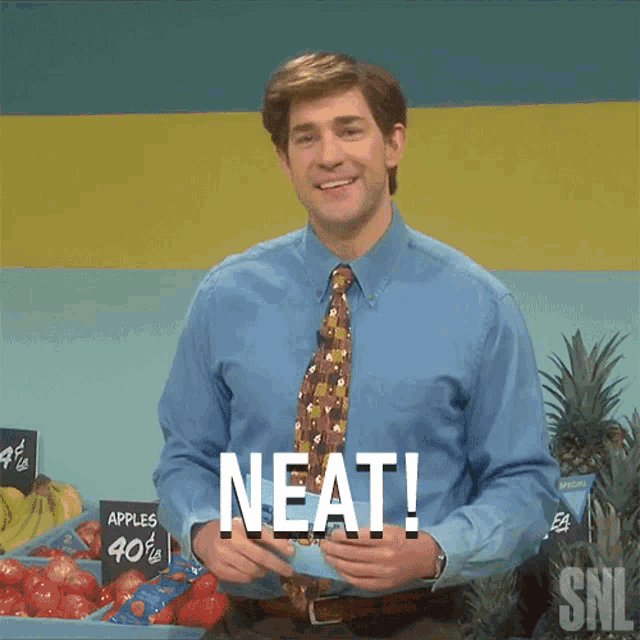 a man in a blue shirt and tie stands in front of a sign that says apples for 40 cents