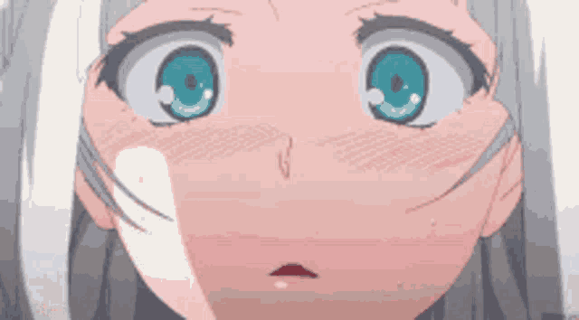 a close up of a girl 's face with blue eyes