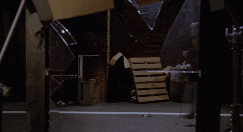 a wooden pallet is sitting in a dark room