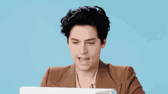 a man sitting in front of a laptop with the words " absolutely " below him