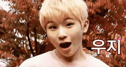 a young boy with blonde hair is making a funny face .