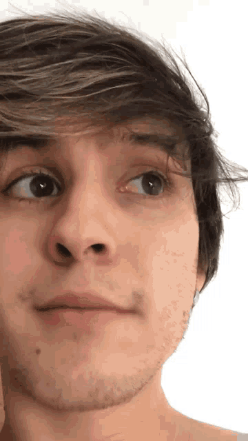 a close up of a young man 's face with a beard