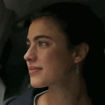a close up of a woman 's face with a smile
