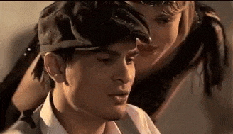 a man and a woman are sitting next to each other and the woman is holding the man 's head .