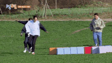 a group of people are playing a game in a field with a sign that says ' k2 ' on it