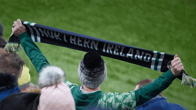 a person holding a scarf that says " northern ireland "