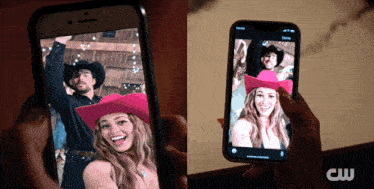 a person is holding a cell phone with a picture of a man and a woman in cowboy hats