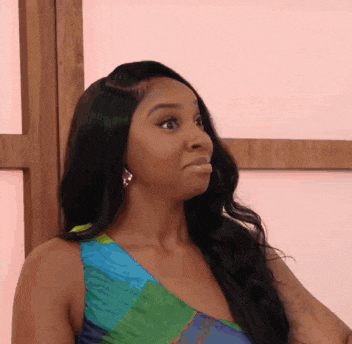 a woman in a colorful dress is making a surprised face