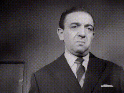 a black and white photo of a man in a suit