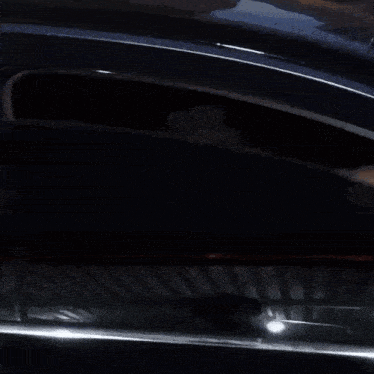 a man looking out of a car window at the camera