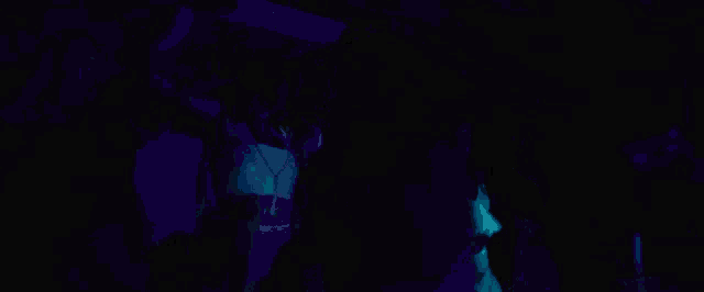 a woman in a white bodysuit is dancing in front of a budweiser sign