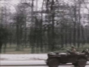 a blurred image of a man driving a jeep with chrl / hds written on the side