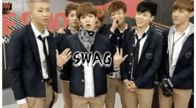 a group of young men are standing together and one of them is wearing a swag jacket .