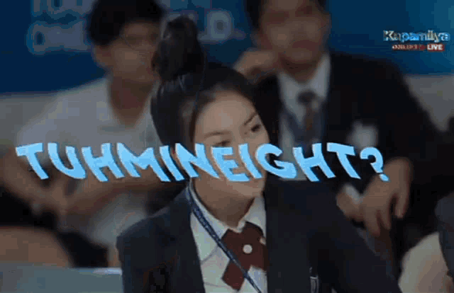 a girl in a school uniform is sitting in a classroom with the words tuhmineight written on the screen