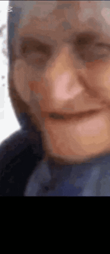 a close up of a person 's face with a scarf around their head .