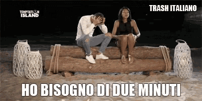 a man and a woman are sitting on a log on the beach with trash italiano written on the bottom