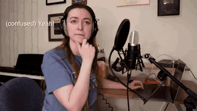 a woman wearing headphones is sitting in front of a microphone with the words " confused yeah " written below her