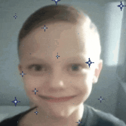a close up of a child 's face with blue stars around his face