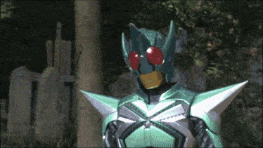 a man in a green and silver armor with red eyes