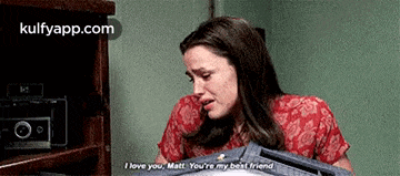 a woman is crying while holding a box and talking to matt .