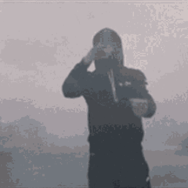 a shadow of a person taking a picture of themselves in the fog .