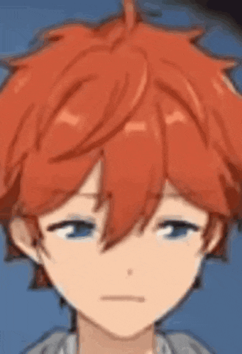 a close up of a boy 's face with red hair and blue eyes .