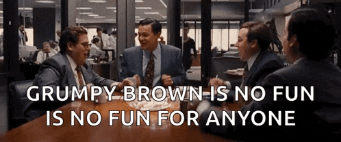 a group of men are sitting around a table with a quote that says grumpy brown is no fun for anyone
