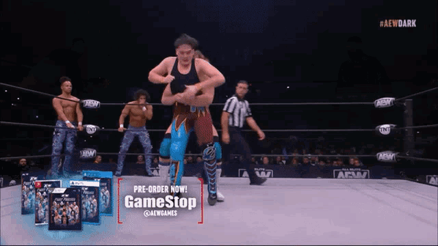 a man in a wrestling ring with a game stop advertisement