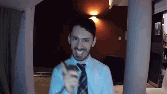 a man with a beard wearing a shirt and tie