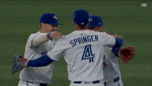 a baseball player with the number 18 on his back hugging another player