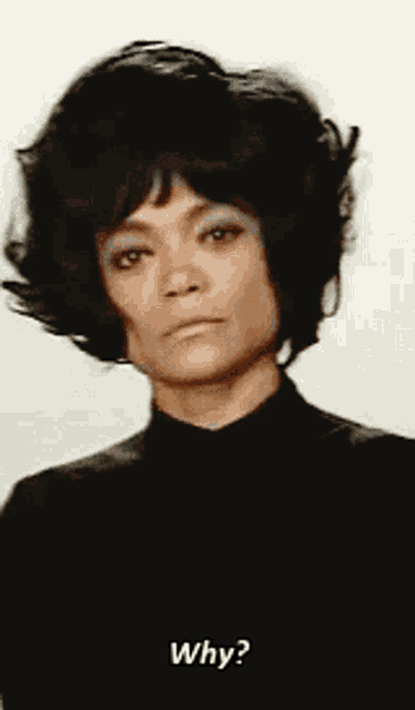 a woman in a black turtleneck is asking the question " why "