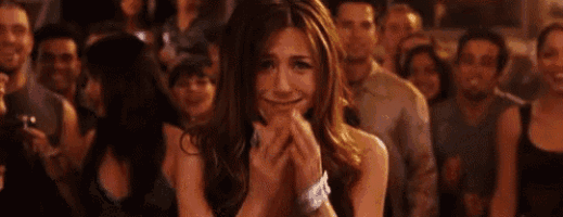 a woman is crying while sitting in front of a crowd of people .