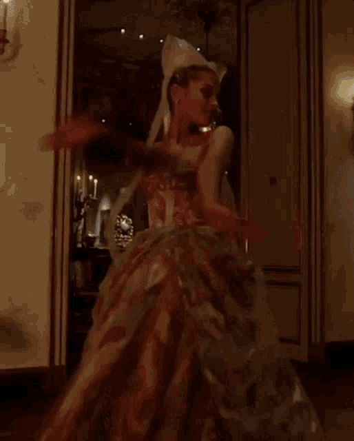 a woman in a wedding dress is dancing in a room .