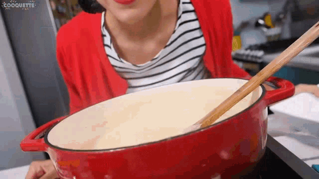 a woman is stirring a pot of food with a wooden spoon and the word coquette is on the bottom
