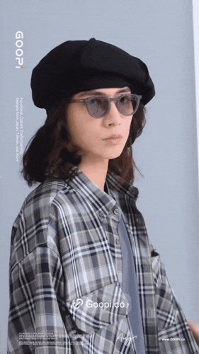 a person wearing sunglasses and a plaid shirt with the word goopi on the bottom right