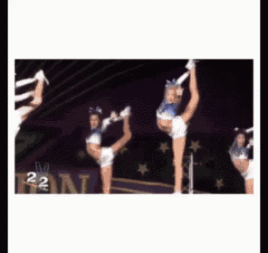 a group of cheerleaders doing a split in front of a banner that says 22
