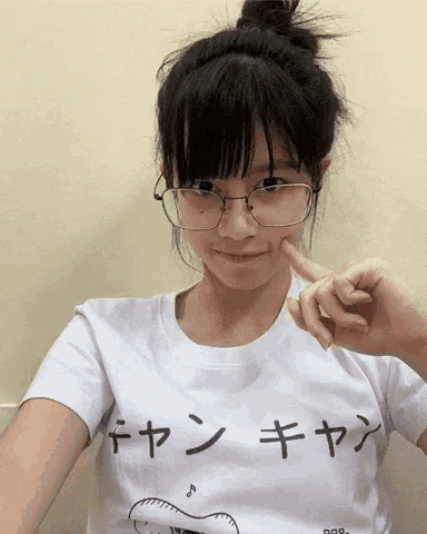 a girl wearing glasses and a white t-shirt with chinese characters on it