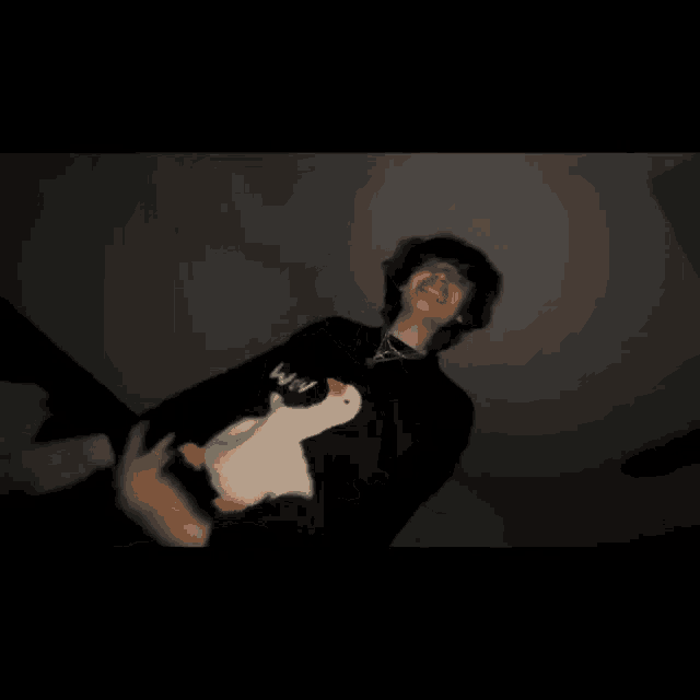 a blurry picture of a young man holding a stuffed duck .