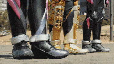 a group of people standing next to each other with one wearing a black and gold armor