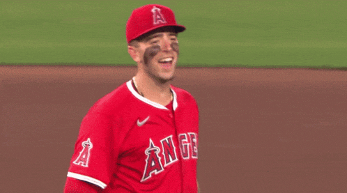 a baseball player wearing a red uniform with angels on the front