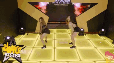 two women are dancing on a stage with the words dance stars in the corner