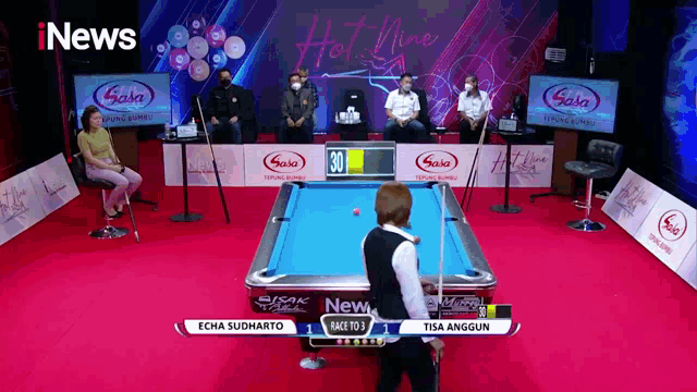 a pool table sponsored by saka is being played