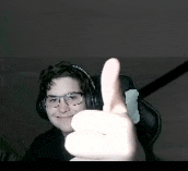 a person wearing headphones and glasses is giving a thumbs up sign .