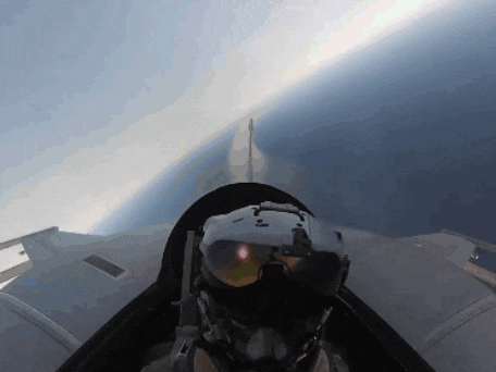 a man wearing a helmet and goggles is flying in the air
