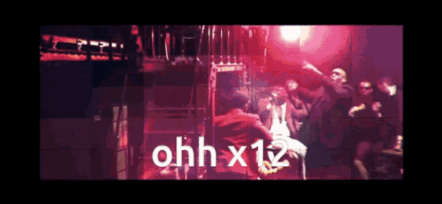 a group of people dancing in a dark room with the words ohh x12 on the bottom