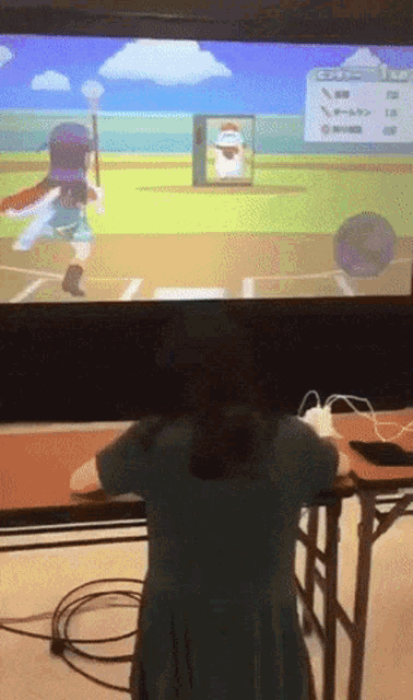a girl is playing a video game on a screen that says ' nintendo ' on it