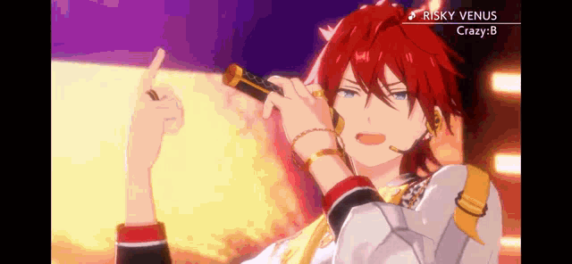 a man with red hair is singing into a microphone and giving a middle finger .