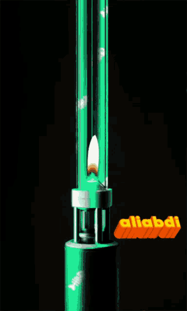 a green object with a candle inside of it and the word alibabi on the bottom