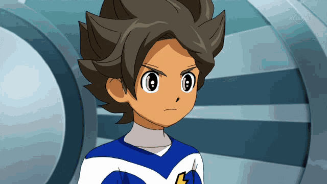 a boy in a blue and white shirt with the letter l on his chest