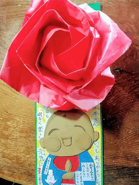 a drawing of a monk with a red rose on top of it